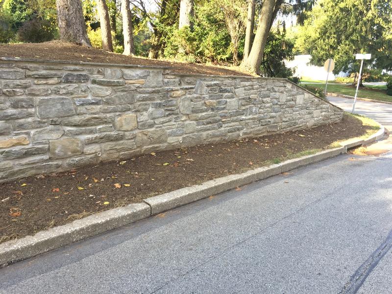 large stone wall along street